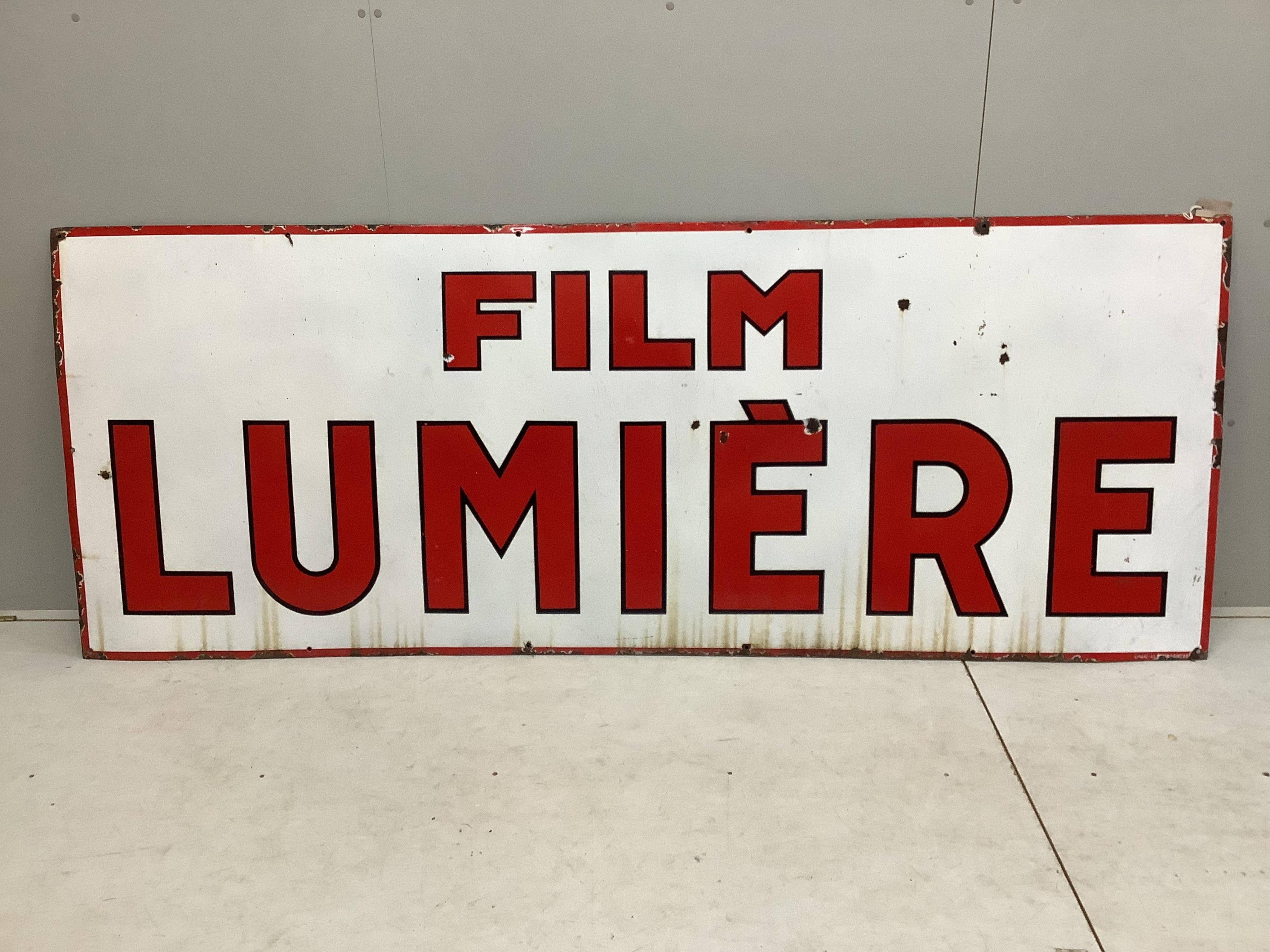 A large vintage French enamel advertising sign 'Film Lumière', width 246cm, height 95cm. Condition - fair